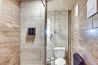 a bathroom with a toilet and a shower at HBG Apt about 3 Mi to Downtown and River! in Harrisburg