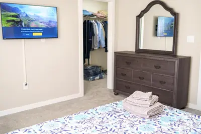 a bedroom with a bed with a dresser and a mirror at Hidden Gem 2 in Norristown