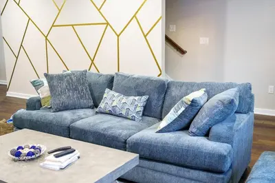 a blue couch in a living room with a table at Hidden Gem 2 in Norristown