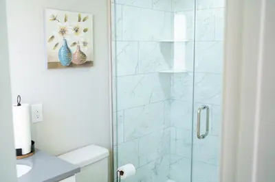a bathroom with a glass shower with a sink at Hidden Gem 2 in Norristown