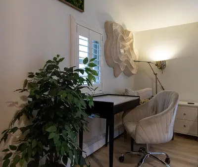 a desk and a chair and a plant in a room at Quiet Cottage In The Woods, with Hot Tub! in Glenmoore