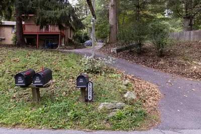 two parking meters sitting on the side of a road at Quiet Cottage In The Woods, with Hot Tub! in Glenmoore