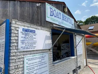 a building with a sign for the front of a restaurant at Quiet Cottage In The Woods, with Hot Tub! in Glenmoore