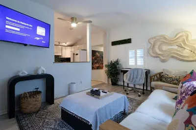 a living room with a couch and a tv at Quiet Cottage In The Woods, with Hot Tub! in Glenmoore