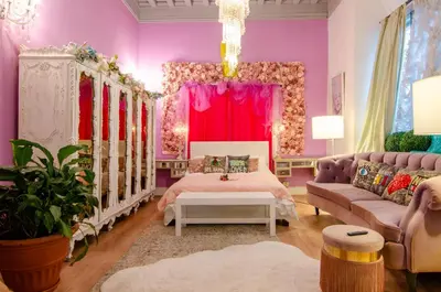a pink bedroom with a bed and a couch at One of a kind home with NYC views in Union City