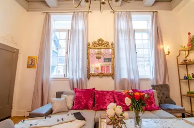 a living room with a couch and two windows at One of a kind home with NYC views in Union City