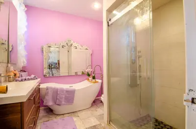 a bathroom with a tub and a sink and a shower at One of a kind home with NYC views in Union City