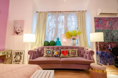 a living room with a pink couch and a window at One of a kind home with NYC views in Union City