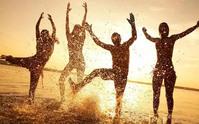 a group of people jumping in the water on the beach at Lovely apartment in New York