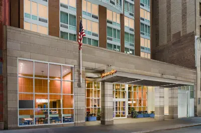 an american flag flying in front of a building at Hampton Inn Times Square Central in New York