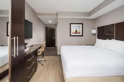 a hotel room with a large bed and a desk at Hampton Inn Times Square Central in New York