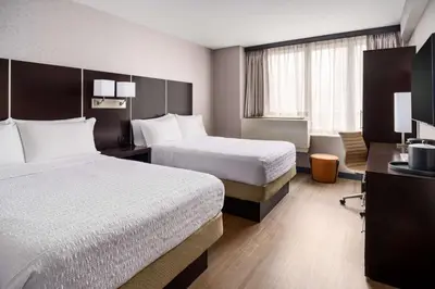 a hotel room with two beds and a window at Hampton Inn Times Square Central in New York