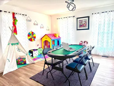 a dining room with a table and chairs and a play area at Game&GatherLodge in Tobyhanna