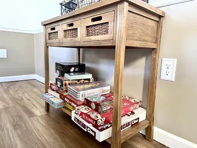 a book shelf with a stack of pizza boxes at Game&GatherLodge in Tobyhanna