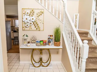 a staircase with a console table in a house at Game&GatherLodge in Tobyhanna