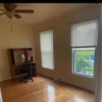 an empty living room with two windows and a ceiling fan at Sweet Home Near Philadelphia in Hatfield