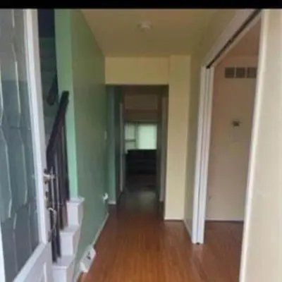 an empty hallway with green walls and a wooden floor at Sweet Home Near Philadelphia in Hatfield