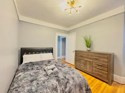 a bedroom with a large bed and a dresser at Waterfront NYC skyline views in Union City