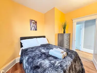 a bedroom with a bed with two towels on it at Waterfront NYC skyline views in Union City