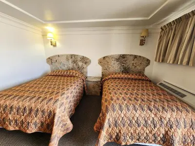 a hotel room with two beds and curtains at Westview Motel in North Bergen