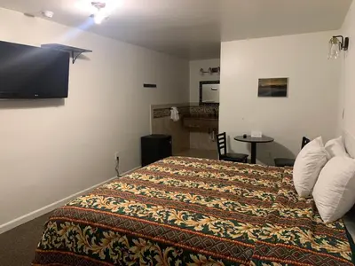 a hotel room with a bed and a flat screen tv at Westview Motel in North Bergen