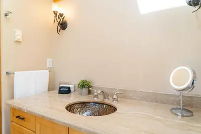 a bathroom sink with a mirror on a counter at 4 Br Mtn Cabin Sauna Hot Tub Fire Pit Putt Putt in Albrightsville