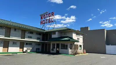 a hotel with a sign on top of it at Winslow Motel in Lyndhurst
