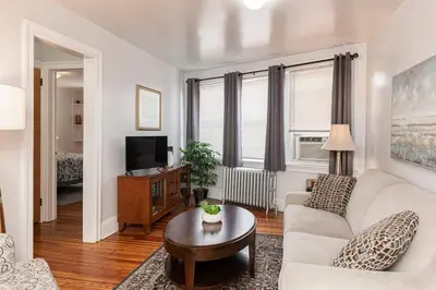 a living room with a couch and a tv at Restaurants Coffee Colleges Bryn Mawr Has It All in Bryn Mawr