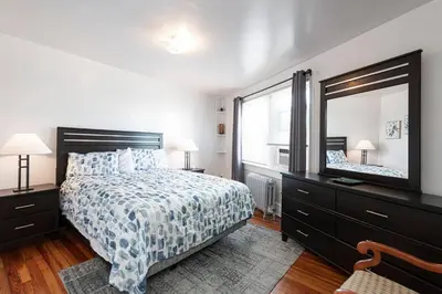 a bedroom with a bed and a large mirror at Restaurants Coffee Colleges Bryn Mawr Has It All in Bryn Mawr