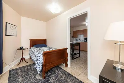 a small bedroom with a bed and a kitchen at Restaurants Coffee Colleges Bryn Mawr Has It All in Bryn Mawr