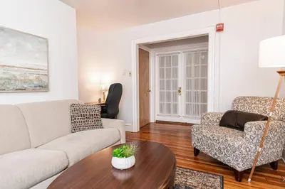 a living room with a couch and a chair and a table at Restaurants Coffee Colleges Bryn Mawr Has It All in Bryn Mawr