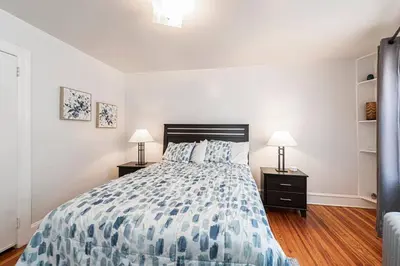 a bedroom with a bed and two night stands with lamps at Restaurants Coffee Colleges Bryn Mawr Has It All in Bryn Mawr