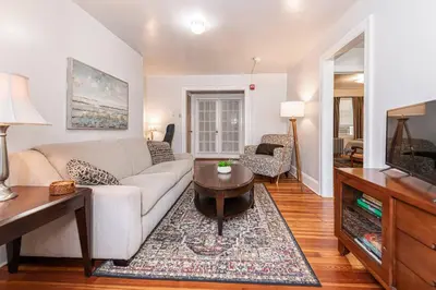 a living room with a couch and a tv at Restaurants Coffee Colleges Bryn Mawr Has It All in Bryn Mawr