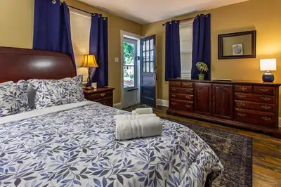 a bedroom with a bed with a blue and white comforter at Ground-Level 2B2B Apt in Bryn Mawr w Parking in Bryn Mawr