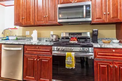 a kitchen with a stove and a microwave at Ground-Level 2B2B Apt in Bryn Mawr w Parking in Bryn Mawr