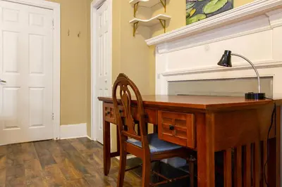a desk with a lamp and a chair in a room at Ground-Level 2B2B Apt in Bryn Mawr w Parking in Bryn Mawr
