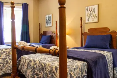 a bedroom with two beds with blue sheets at Ground-Level 2B2B Apt in Bryn Mawr w Parking in Bryn Mawr