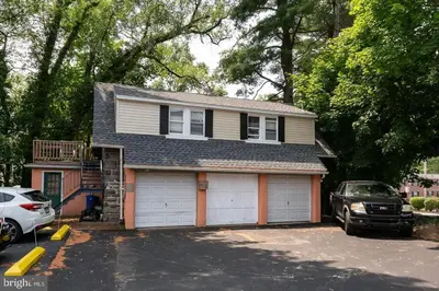 a house with a car parked in a parking lot at Ground-Level 2B2B Apt in Bryn Mawr w Parking in Bryn Mawr