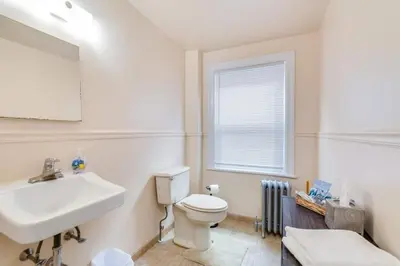 a bathroom with a white toilet and a sink at Colleges Bistros History Come See The Main Line in Bryn Mawr