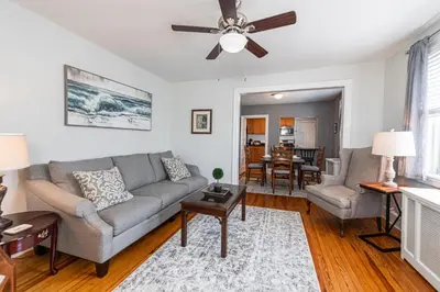 a living room with a couch and a ceiling fan at Bryn Mawr GemBalconyDedicated Parking50TV in Bryn Mawr