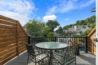 a patio with a table and chairs on a balcony at Bryn Mawr GemBalconyDedicated Parking50TV in Bryn Mawr