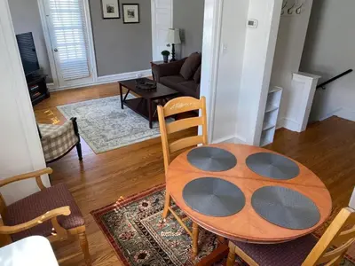 a living room with a table and a couch at 2mins DTPatioParking50 Roku TV400 Mbps in Bryn Mawr