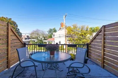 a patio with a table and chairs on a fence at 2mins DTPatioParking50 Roku TV400 Mbps in Bryn Mawr