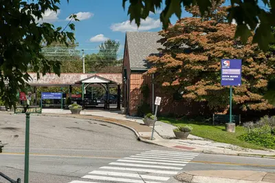 an empty street with a sign on a crosswalk at 2mins DTPatioParking50 Roku TV400 Mbps in Bryn Mawr