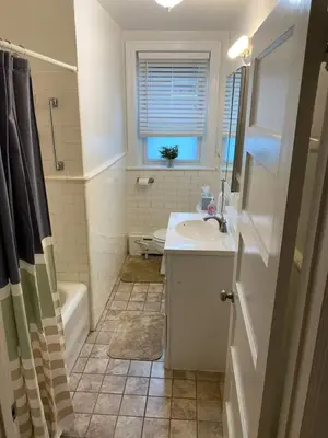 a bathroom with a sink and a toilet and a tub at 2mins DTPatioParking50 Roku TV400 Mbps in Bryn Mawr
