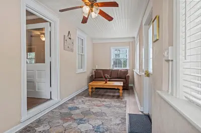 a living room with a ceiling fan and a couch at Stay At Our Tasteful, Private, & Elegant Abode in Devon