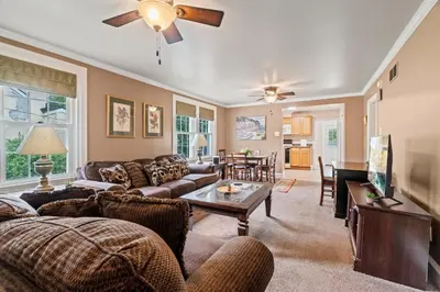 a living room with a couch and a table at Stay At Our Tasteful, Private, & Elegant Abode in Devon