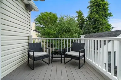 two chairs and a table on a deck at Stay At Our Tasteful, Private, & Elegant Abode in Devon