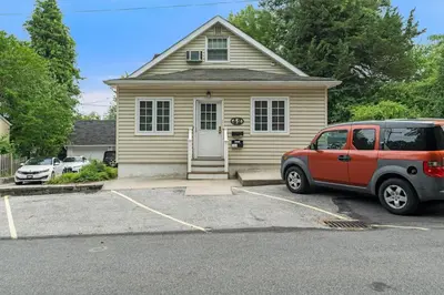 a red van parked in front of a house at Stay At Our Tasteful, Private, & Elegant Abode in Devon