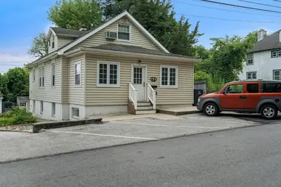 a house with a car parked in front of it at Stay At Our Tasteful, Private, & Elegant Abode in Devon